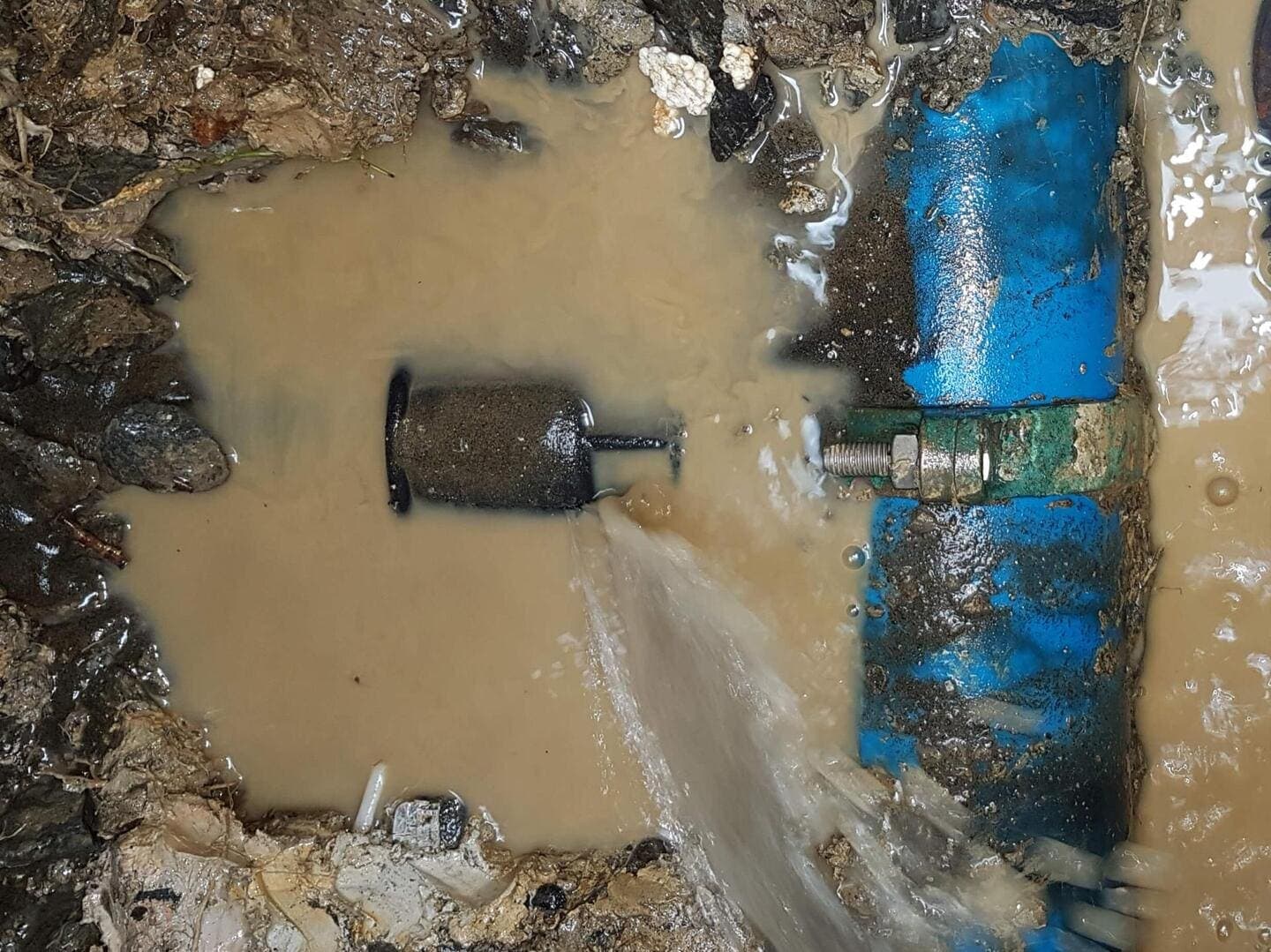 Underground leak excavation exposing a water pipe for repair